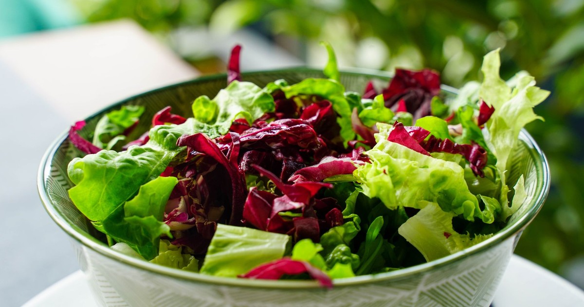 A colorful, leafy greens salad in a patterned bowl. Perfect for healthy eating inspiration.