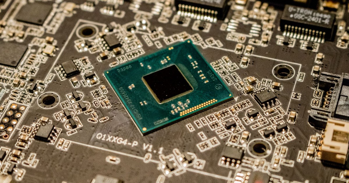 Detailed view of a microchip on a printed circuit board, showcasing electronic components.