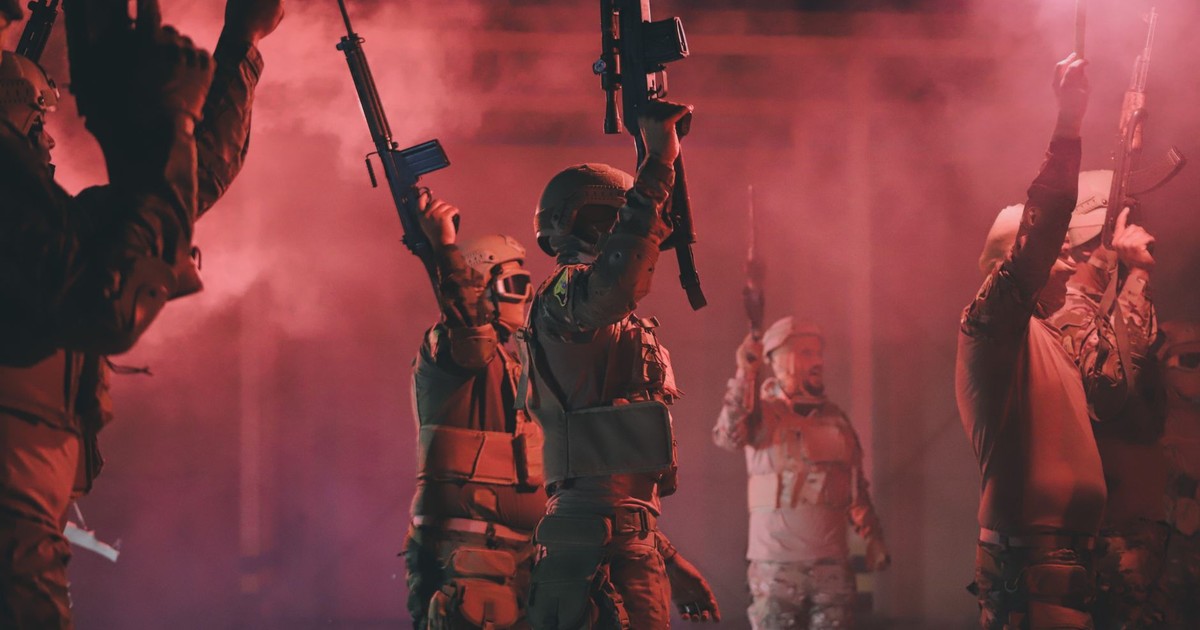 Libyan soldiers holding rifles and red flares in a dynamic military scene.
