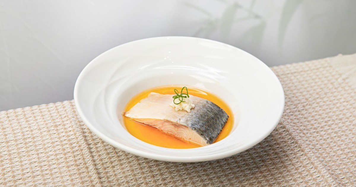 Delicious salmon fillet served in citrus sauce, elegantly plated for a gourmet dining experience.