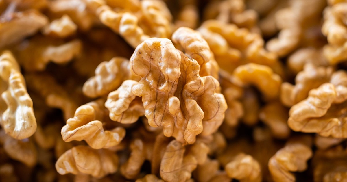 Detailed macro shot of fresh, organic walnuts with textured shells, perfect for food blogs.