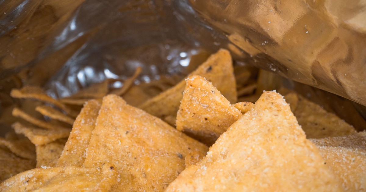 Crispy tortilla chips in a silver foil bag, perfect for snack lovers.