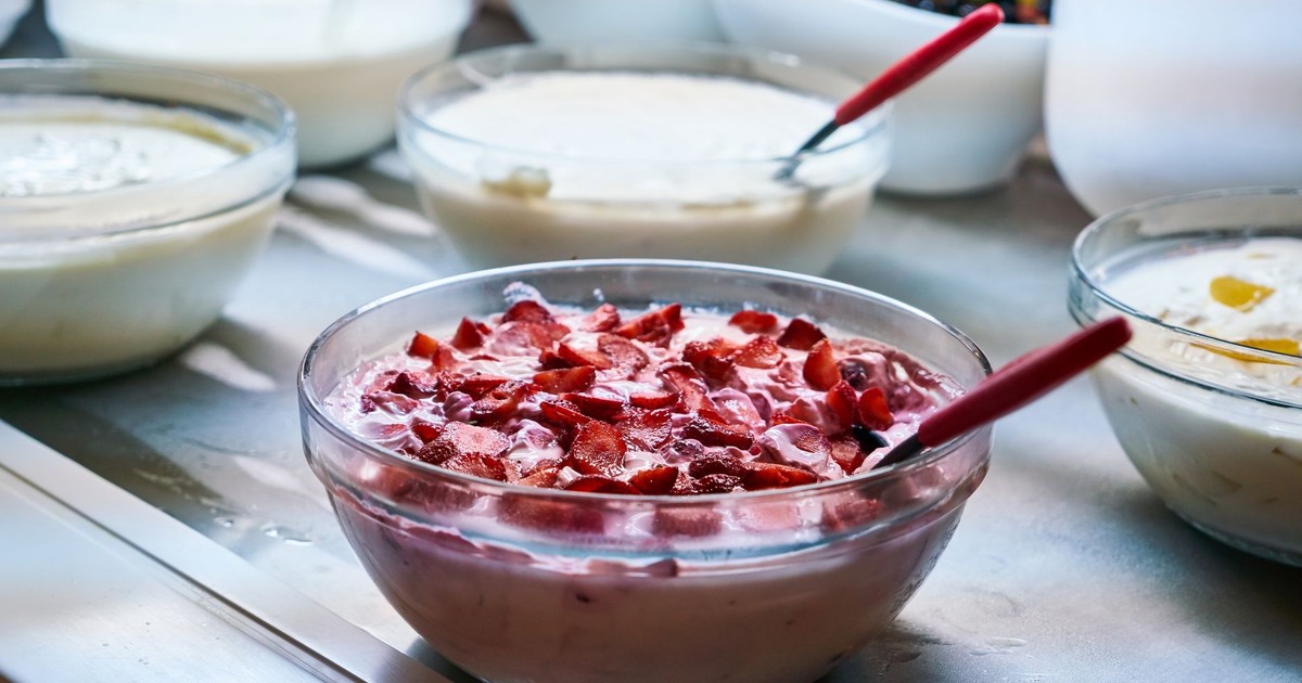A variety of homemade yogurt dishes with fresh fruit toppings in bowls, perfect for breakfast or a healthy snack.