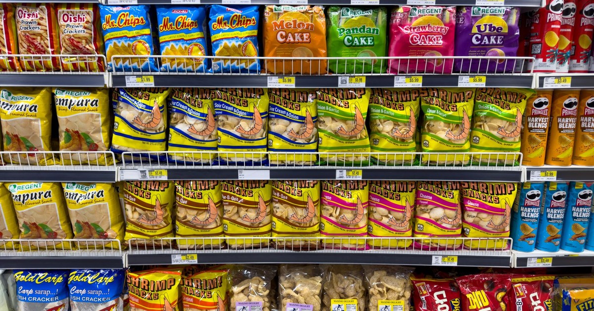 Colorful snack packages neatly displayed in a supermarket aisle showcasing Asian food variety.