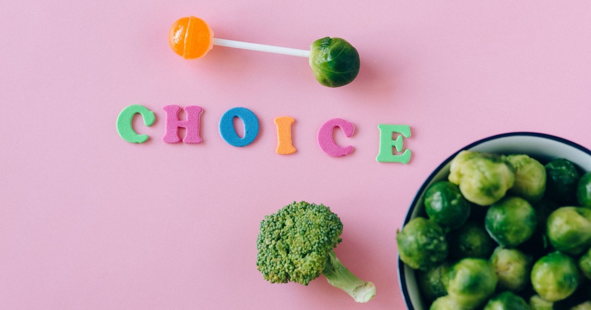 Colorful depiction of healthy and sweet food choices on pink backdrop.