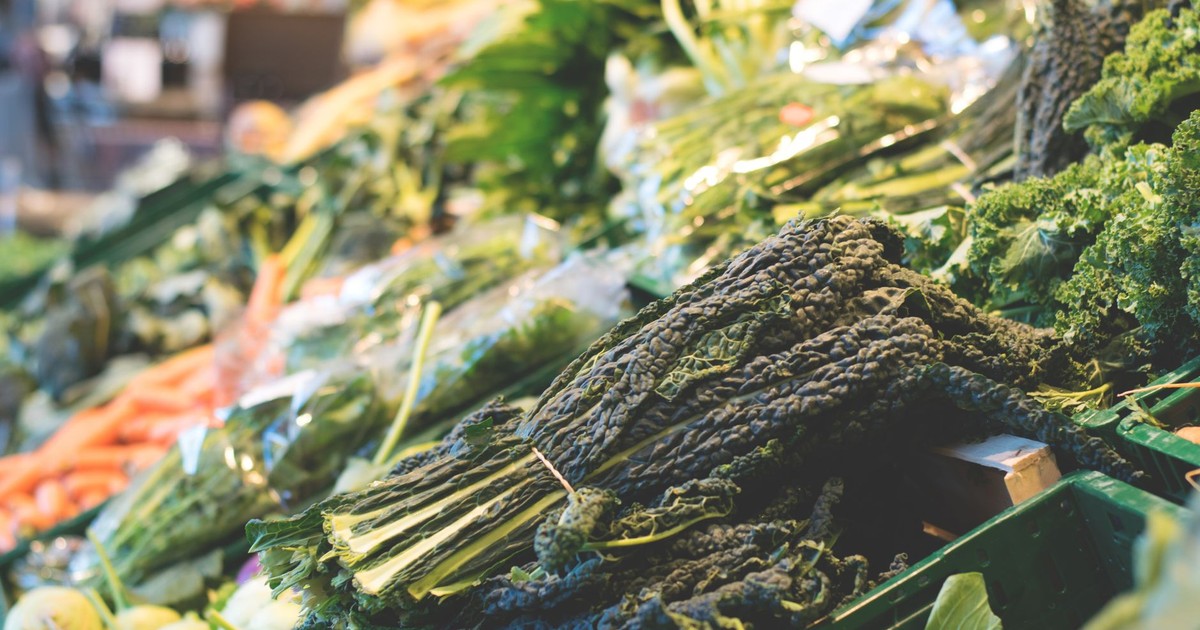 A vibrant display of fresh organic vegetables at a local market stall, showcasing healthy eating.