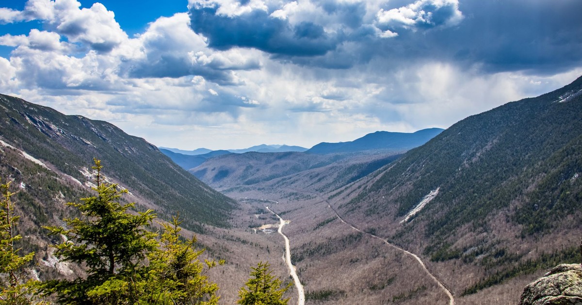 Breathtaking view of a mountain valley under a dramatic sky in New Hampton, NH.