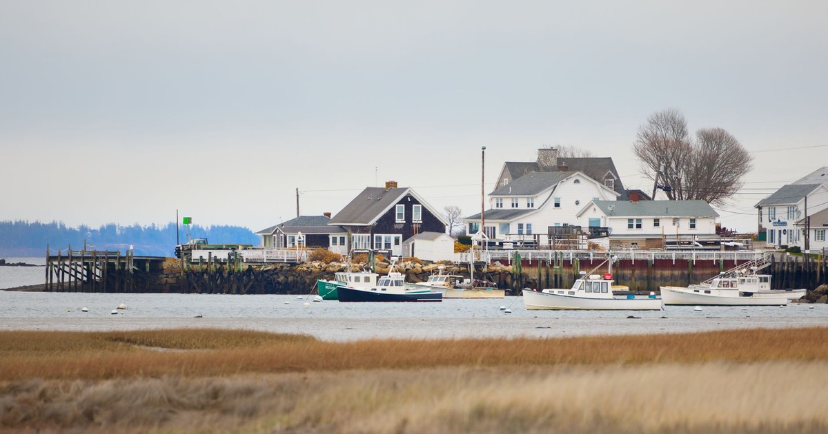Quaint coastal town view with boats and homes in Biddeford, Maine, USA.