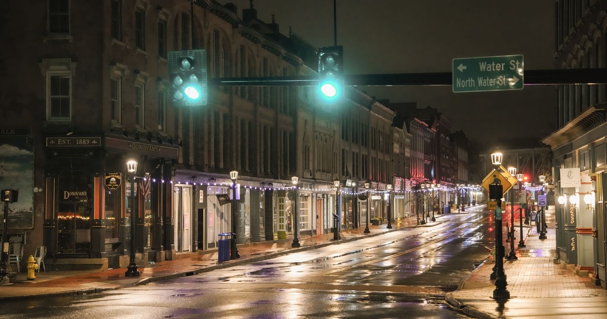 A quiet, illuminated street scene in downtown Norwalk after rain.