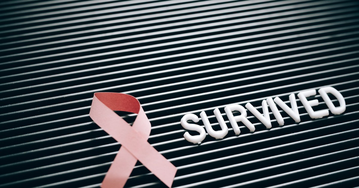 Conceptual image of breast cancer survival with pink ribbon and 'Survived' message.