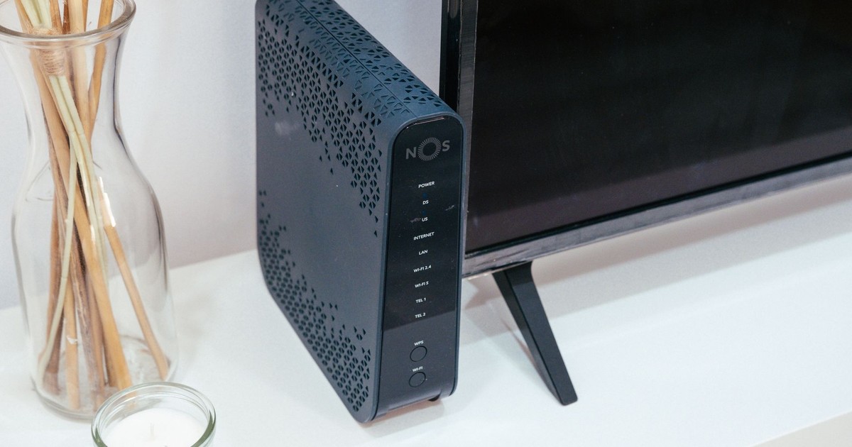 A sleek home technology setup featuring a router, glass decoration, and television.