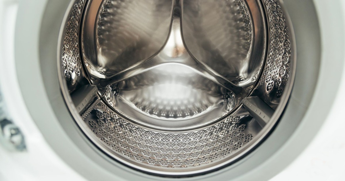 Detailed view of a clean, modern washing machine drum, showcasing shiny stainless steel interior.