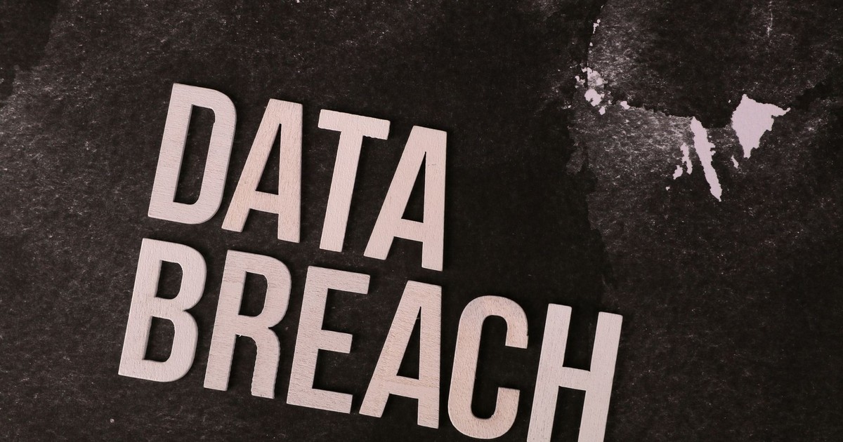 A conceptual image highlighting the issue of data breaches, featuring bold text on a textured background.