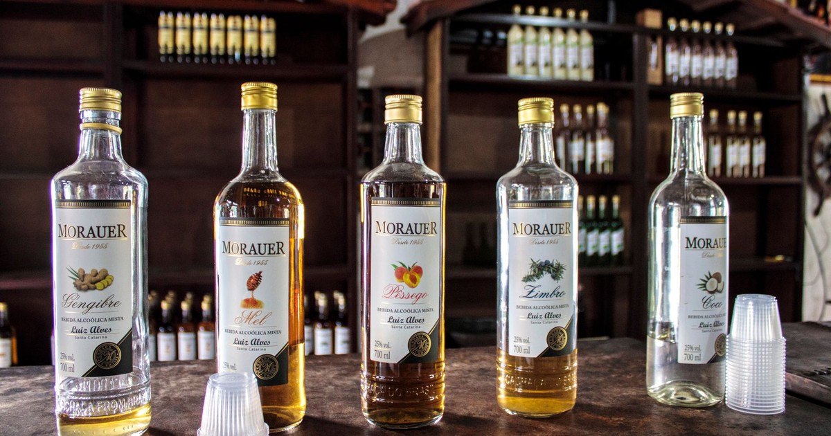 A variety of Morauer spirits, including honey and peach flavors, on a bar counter.