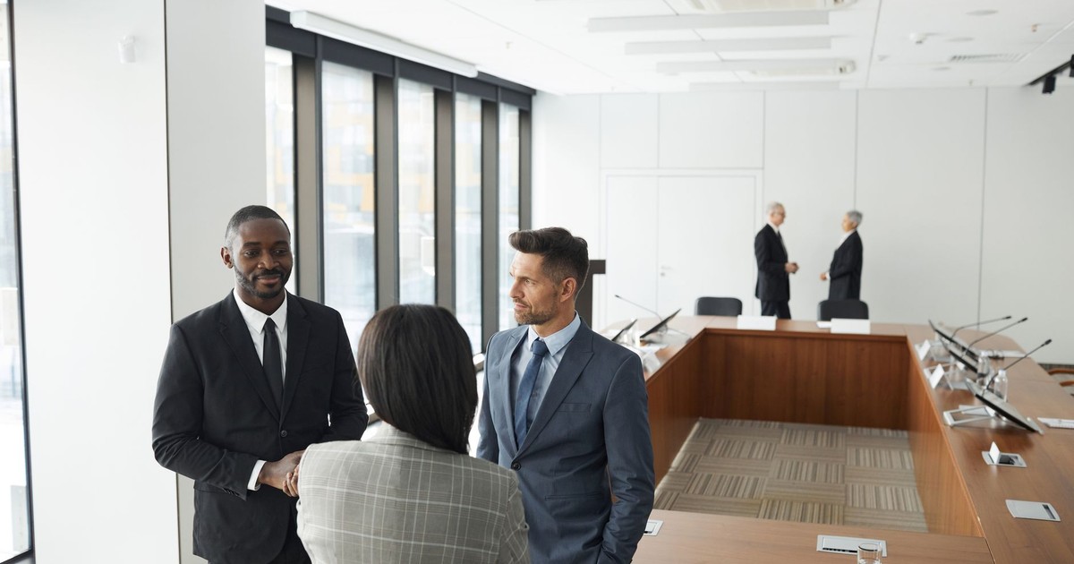 Business professionals engaging in a meeting in a modern conference room.