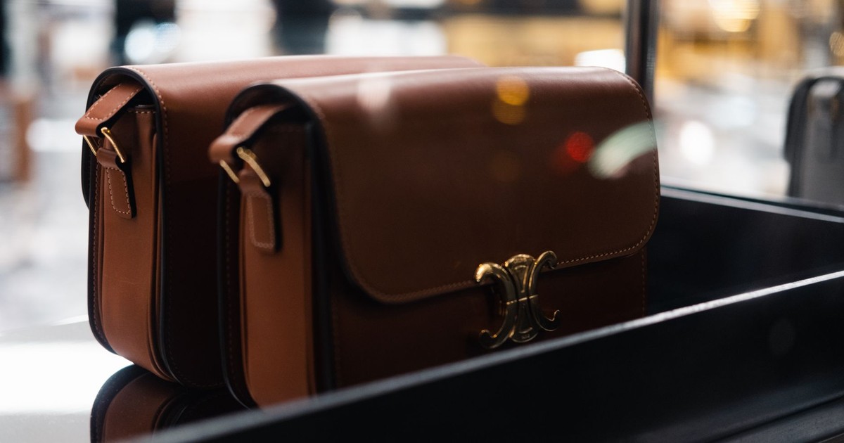 Stylish brown leather handbags showcased indoors with soft focus lights.