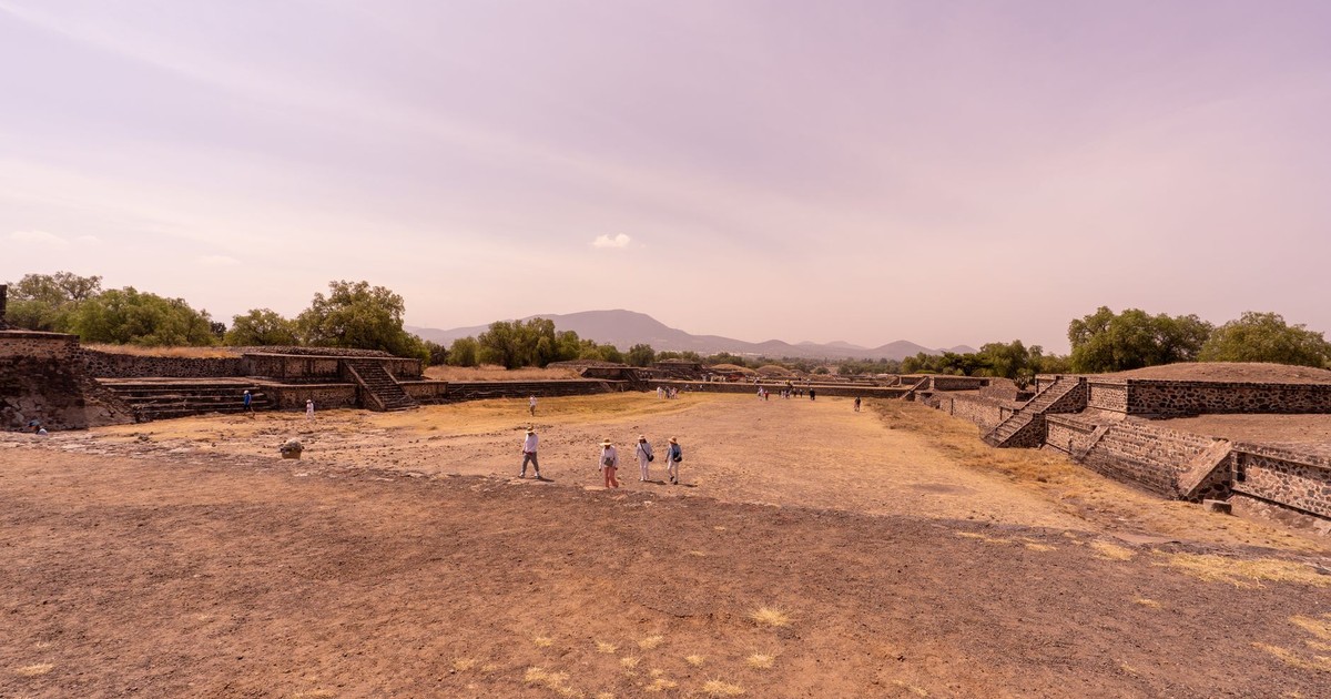A stunning wide-angle view of the ancient Teotihuacan site, showcasing historical ruins under a clear sky.