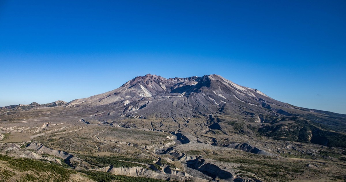 A stunning aerial shot of Mount St. Helens, showcasing its expansive crater and surrounding landscape.